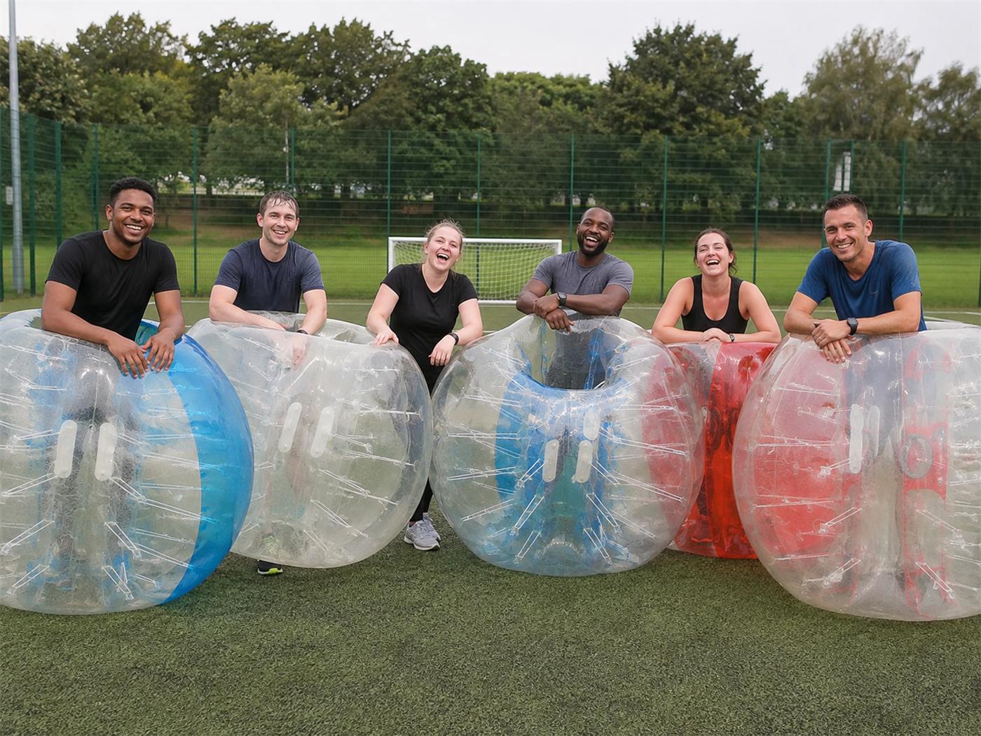 Group of adults with inflatable Zorb football bubbles Group of adults with inflatable Zorb football bubbles